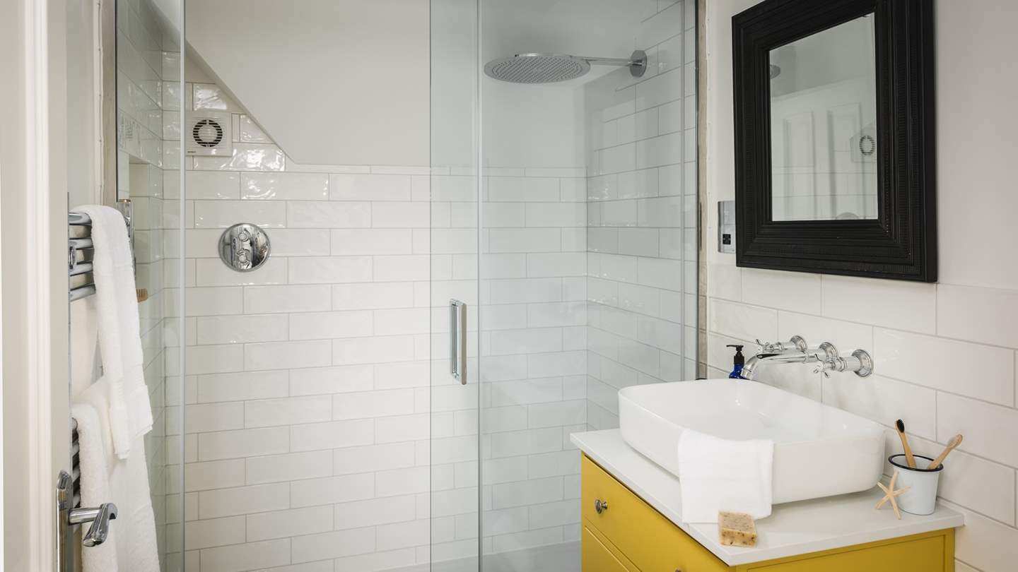 This bedroom is paired with an en suite with a large shower and vanity basin