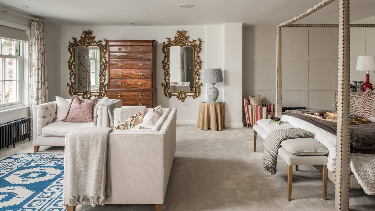 A spacious sanctuary on the first floor, it comfortably houses a four-poster super king-sized bed, sofa, two armchairs and a TV