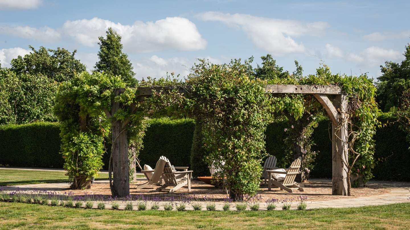 A cosy pergola offers an intimate setting with space for eight