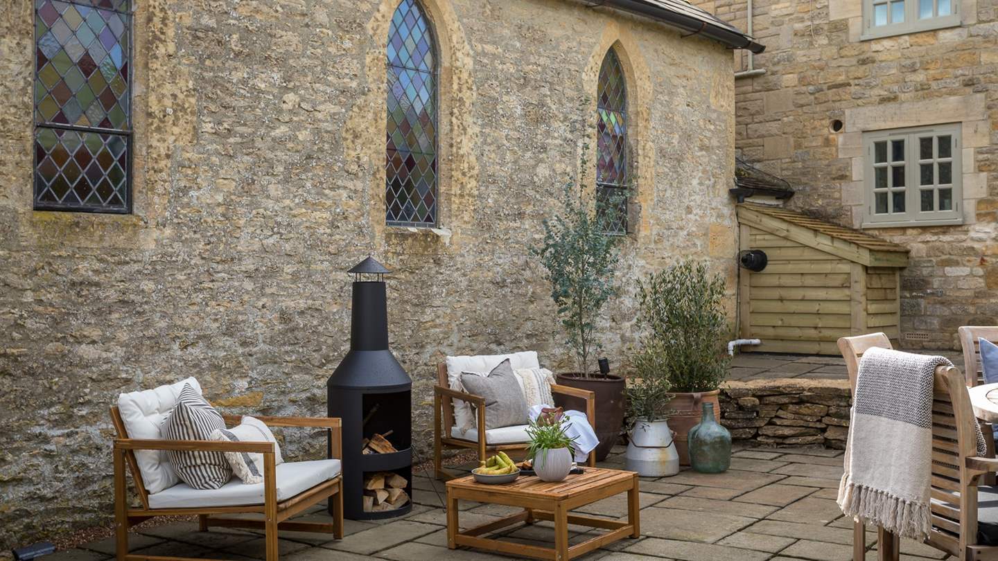 A casual seating area gathers around the charming wood burning stove...