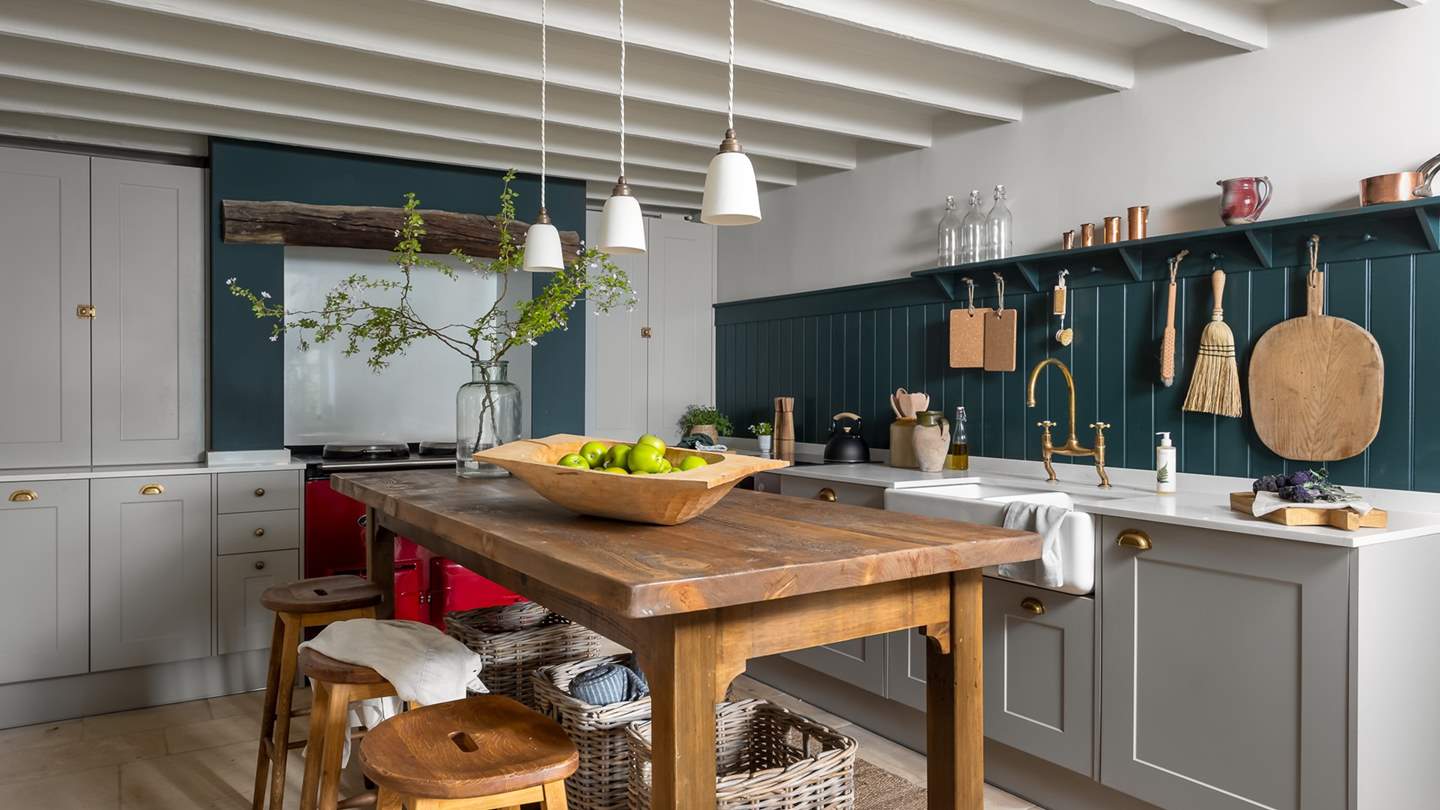 With teal wood panelling and a contrasting cherry-red AGA, this is an inspiring space for budding chefs...