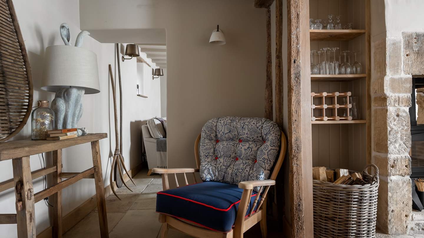Tucked in a corner, a blue paisley print armchair offers a serene spot for those seeking solitude.