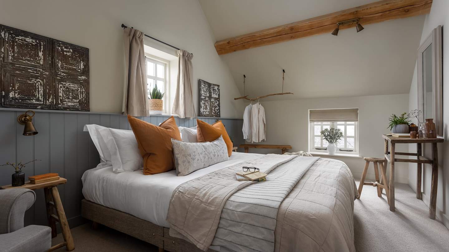 With tasteful wall art and burnt orange inflections, bedroom two is equally pretty...