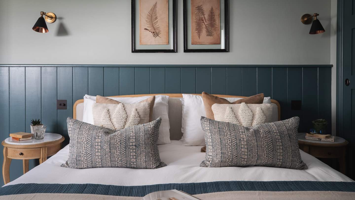 Beautiful in blue, the magnificent master bedroom is dressed in gorgeous shades of slate