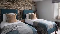 A heavenly space for two, the second bedroom has twin single beds adorned in downy duvets and super-soft throws