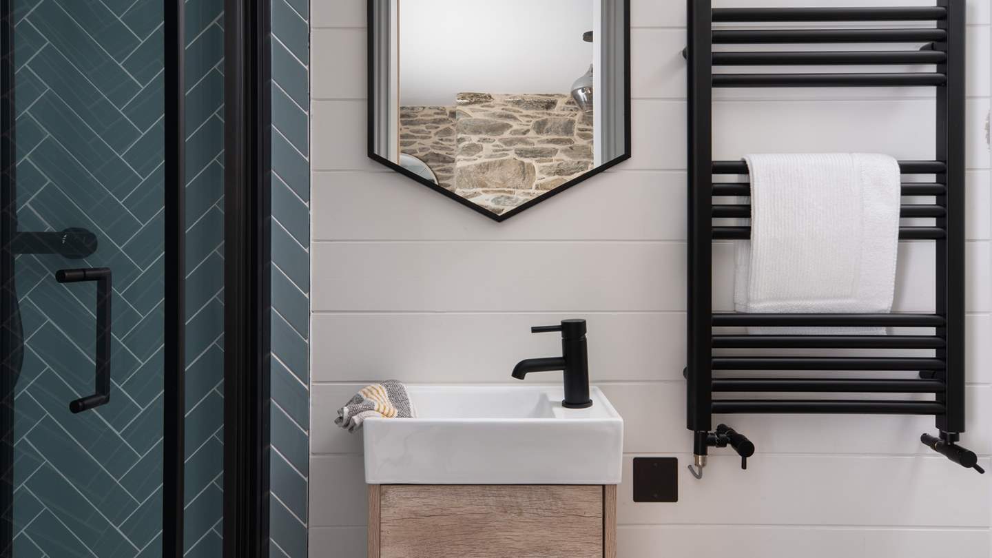 There's also a stunning ensuite with herringbone tiling, balanced with bright white panelling