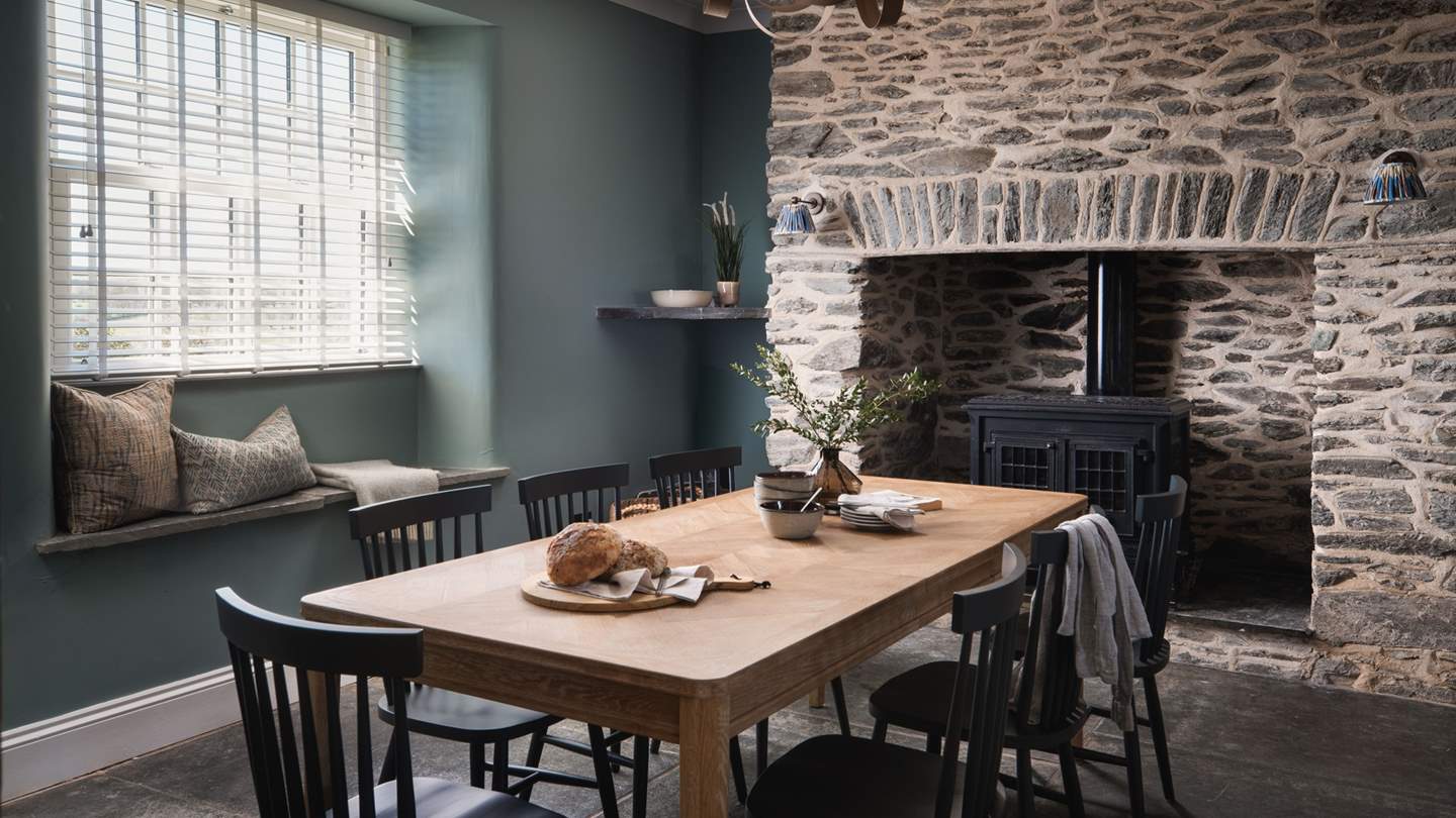 Adjoined by a dining area, it features flagstone floors, exposed beams and an original stone fireplace, all nodding to the residence’s historic roots