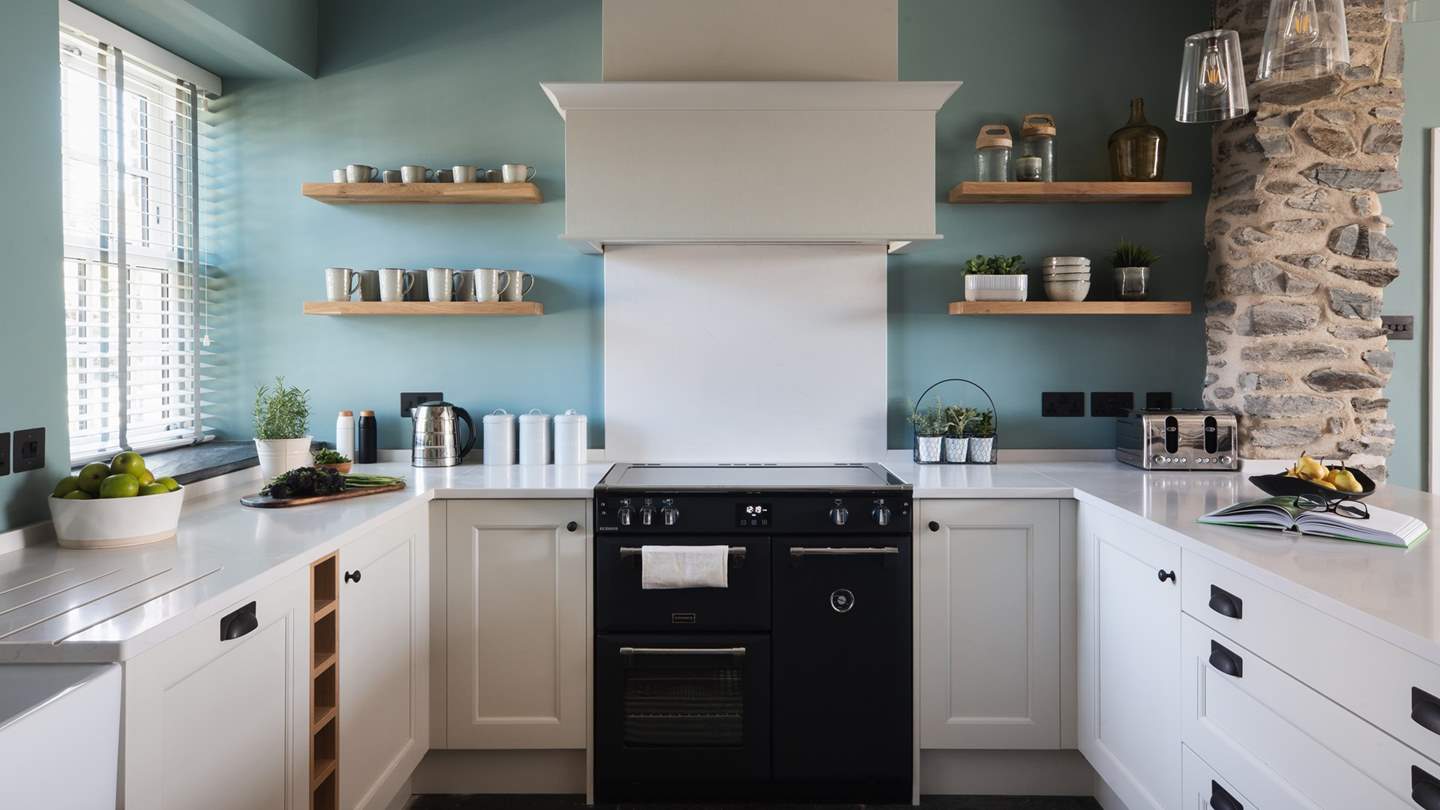 Pretty-as-a-picture, the seafoam-blue walls hint at the retreat’s coastal reaches, while the off-white hues and wood tones add freshness and warmth throughout