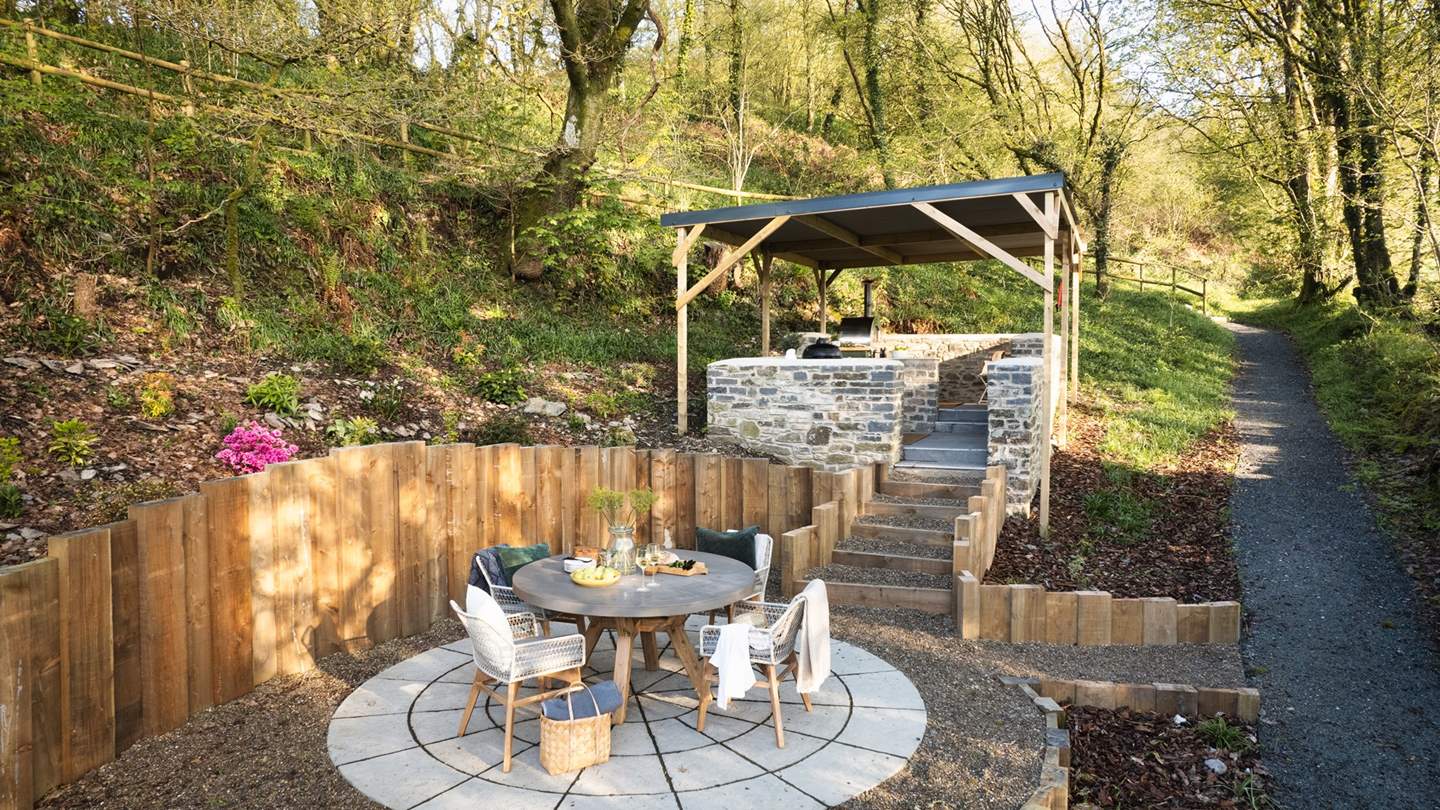 For alfresco feasts, an outdoor kitchen sits next to the house and promises unforgettable moments gathered together