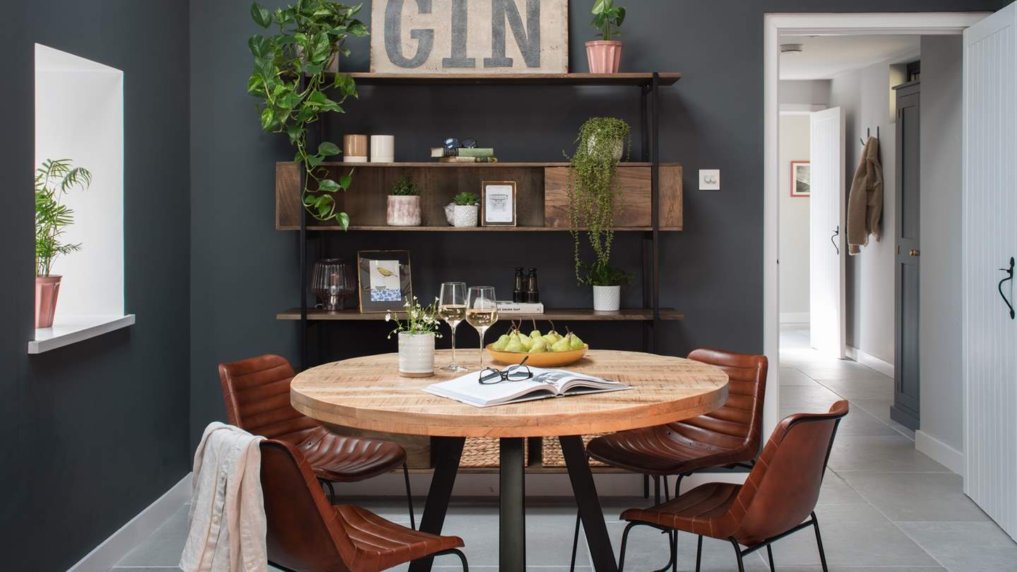 A mango-wood round games table provides the perfect setting for post-dinner drinks with board games 