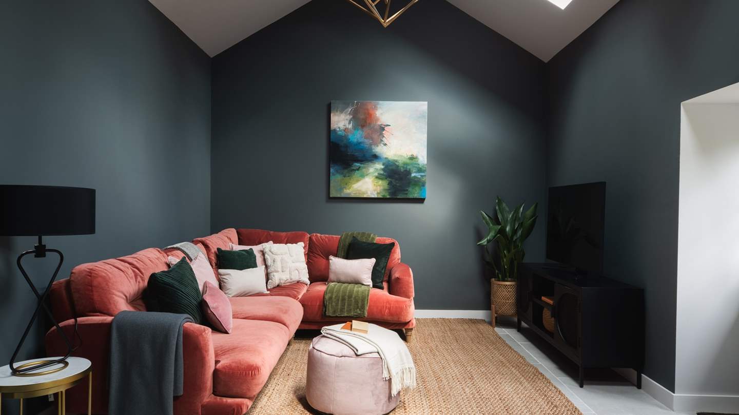 For additional recreation and relaxation, a games and entertainment area resides in a separate room, dressed in dark, ambient tones and natural, textured decorations