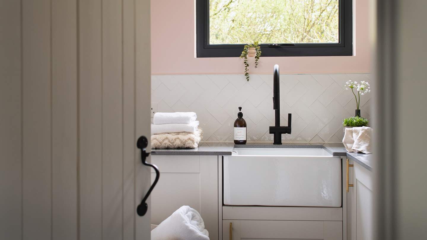 The utility room is complete with a washing machine and tumble dryer