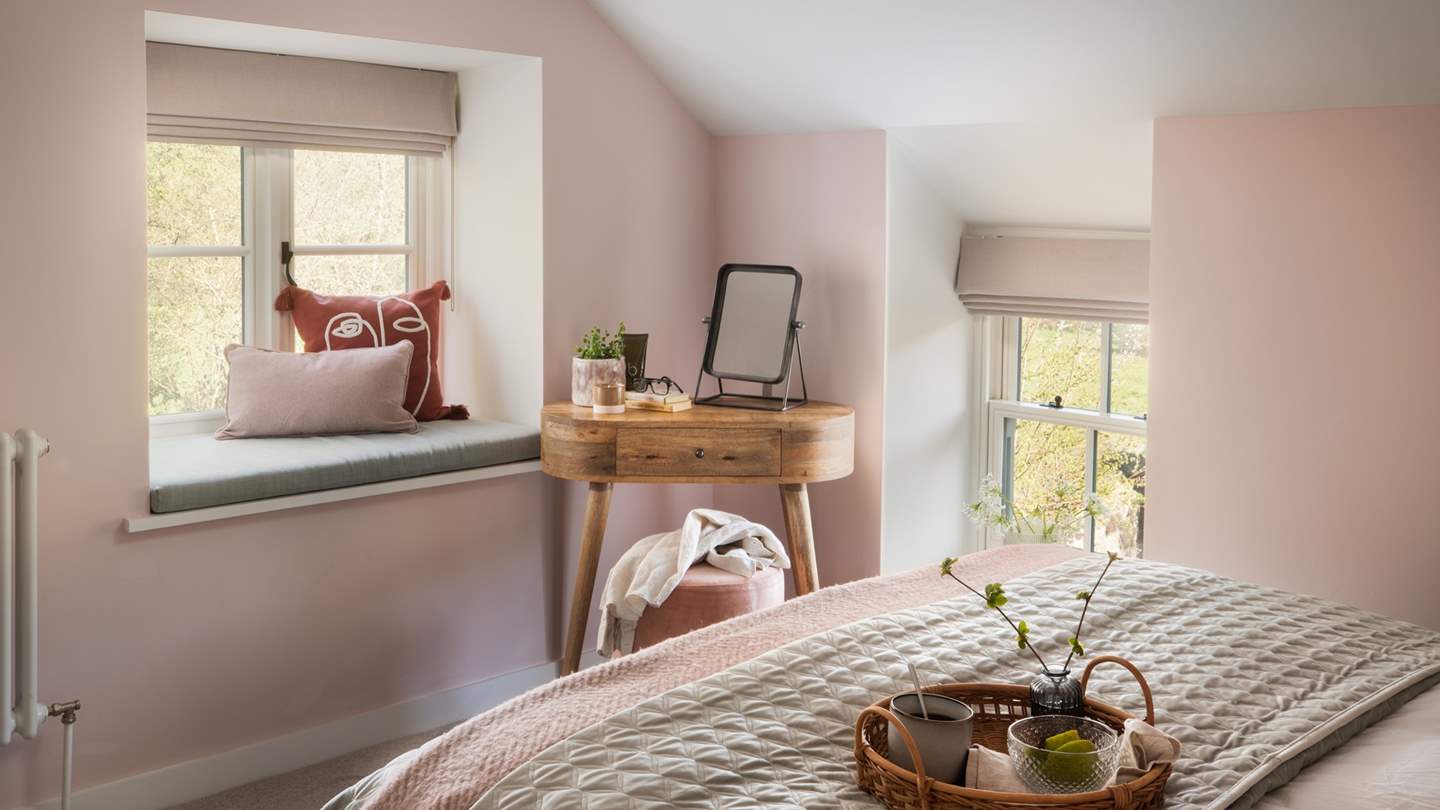 Embodying a calm, peaceful atmosphere, it is decorated in soft rose and sage tones that reflect the natural colour palette beyond the bedroom window