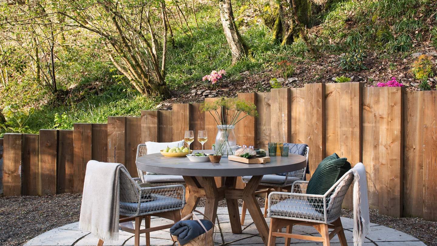 Ensuring everyone has somewhere comfortable to banquet in style, an adjacent dining area is found with a circle table and chairs for four