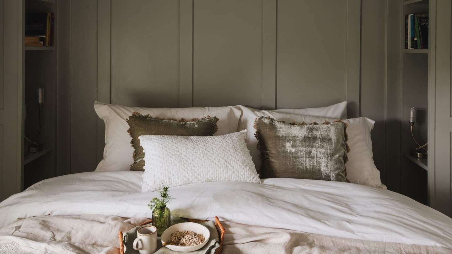 The master bed is dressed in complementary cushions and throws to evoke the most soothing slumbers