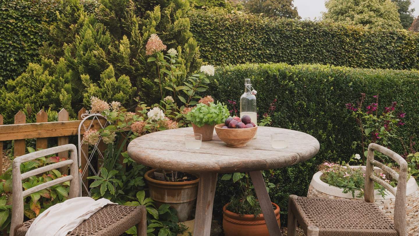 A cocktail table with bar stools promises the perfect setting for toasting tipples at sunset
