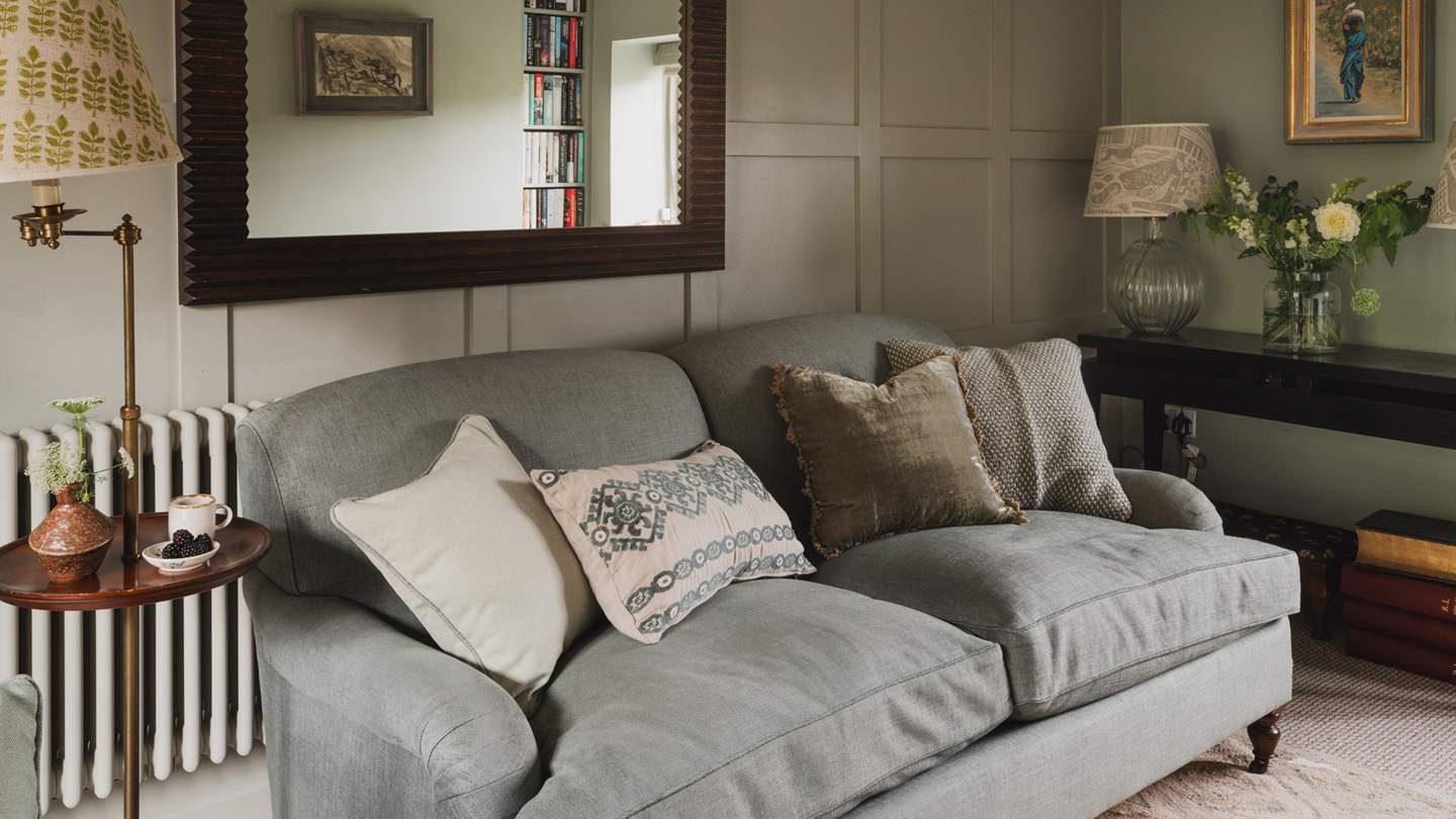 Uncover a cosy window seat, armchair and a sofa in soothing tones of sage