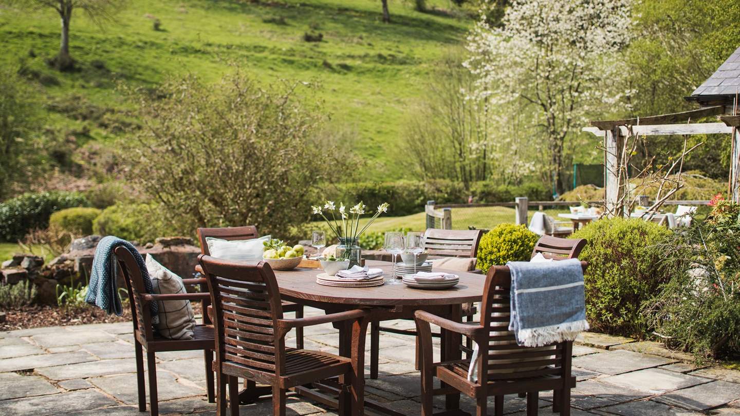 Alternatively, a wooden dining table for eight can be found on the garden patio
