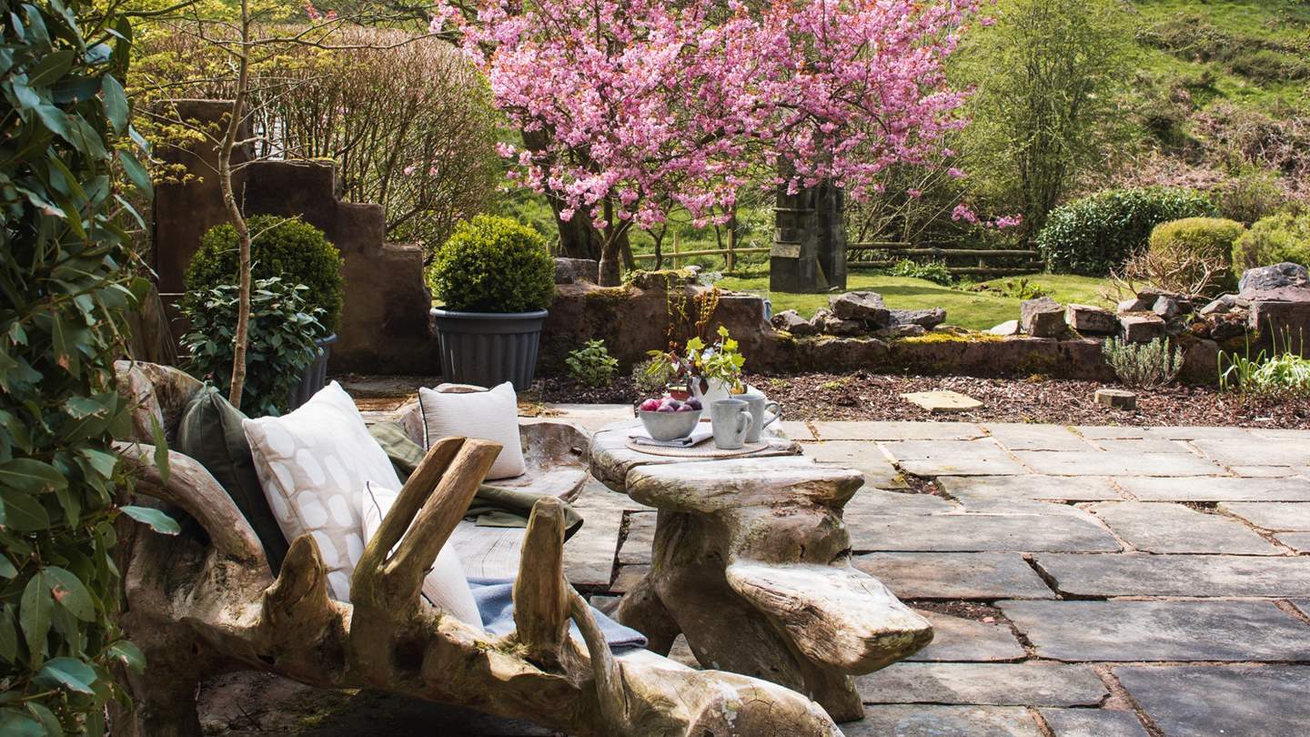 We just adore the patio's addition of a handmade oak bench with table 