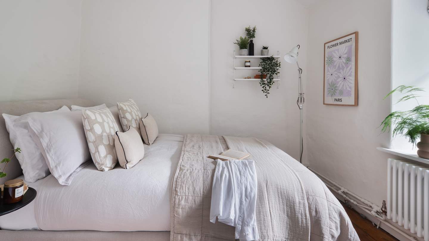 Just next door is the third bedroom with a double bed, continuing with the soft, neutral tones presented throughout 