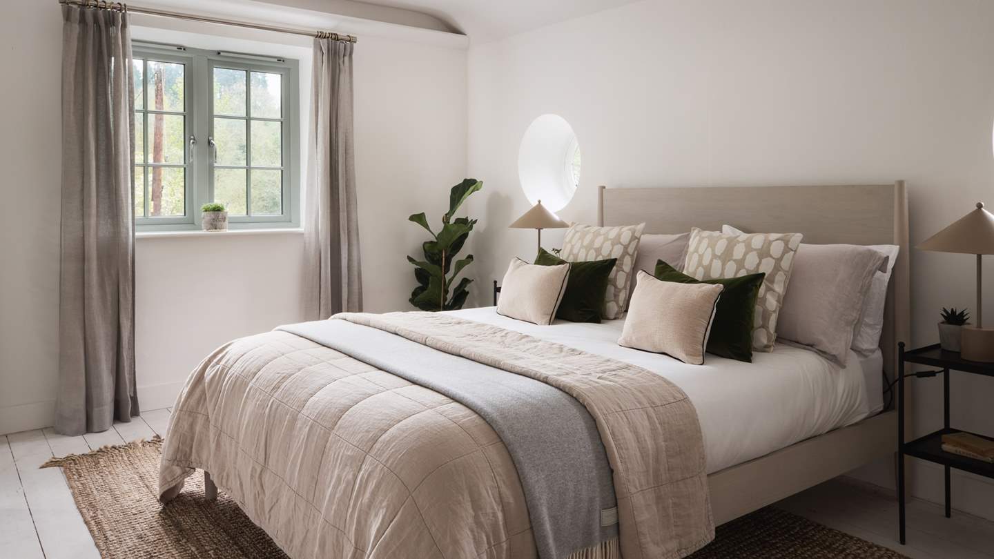 The neutral-toned second bedroom is equally charming