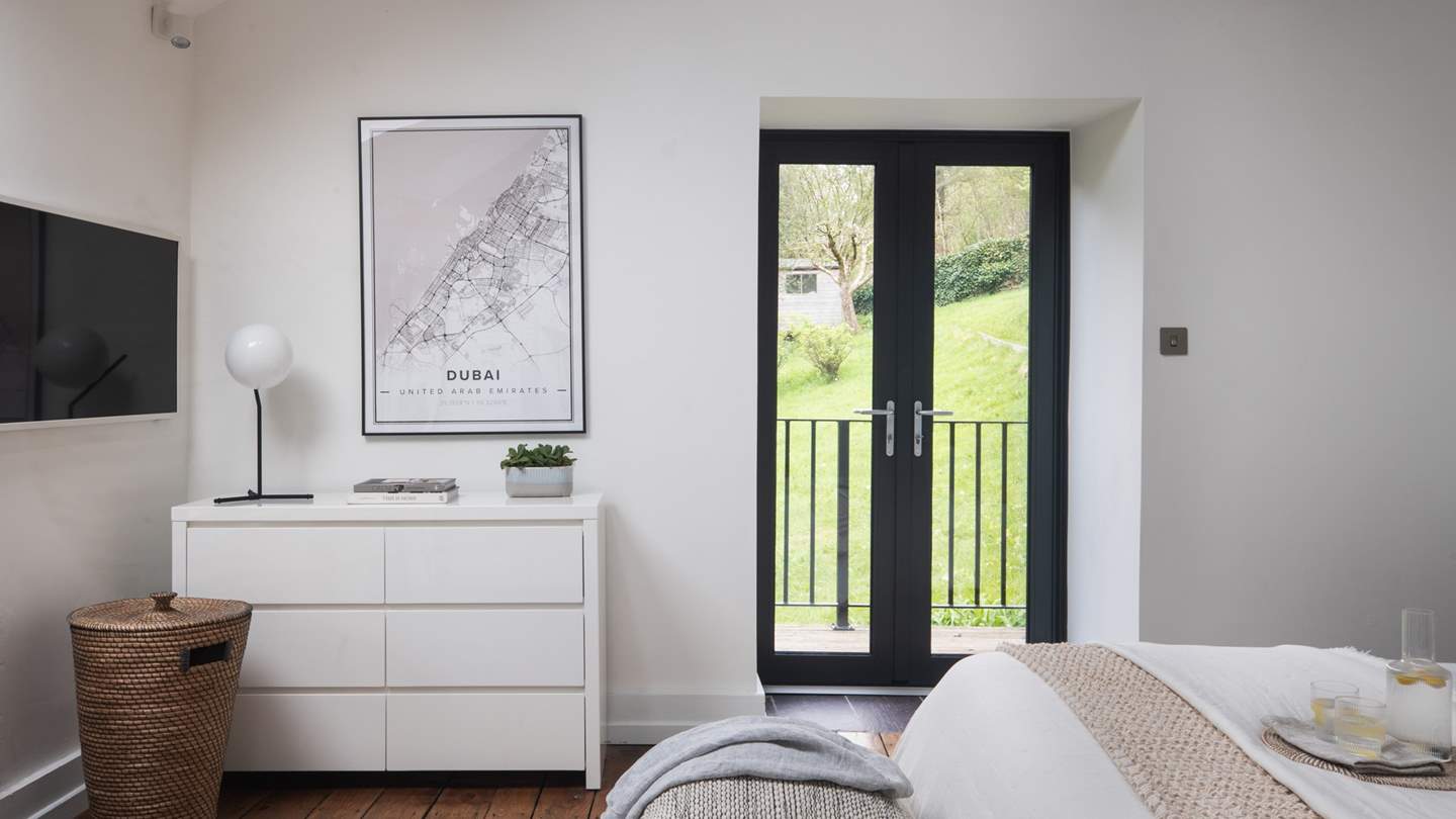 This boudoir features a gorgeous, vaulted oak beamed ceiling along with a Juliet balcony 