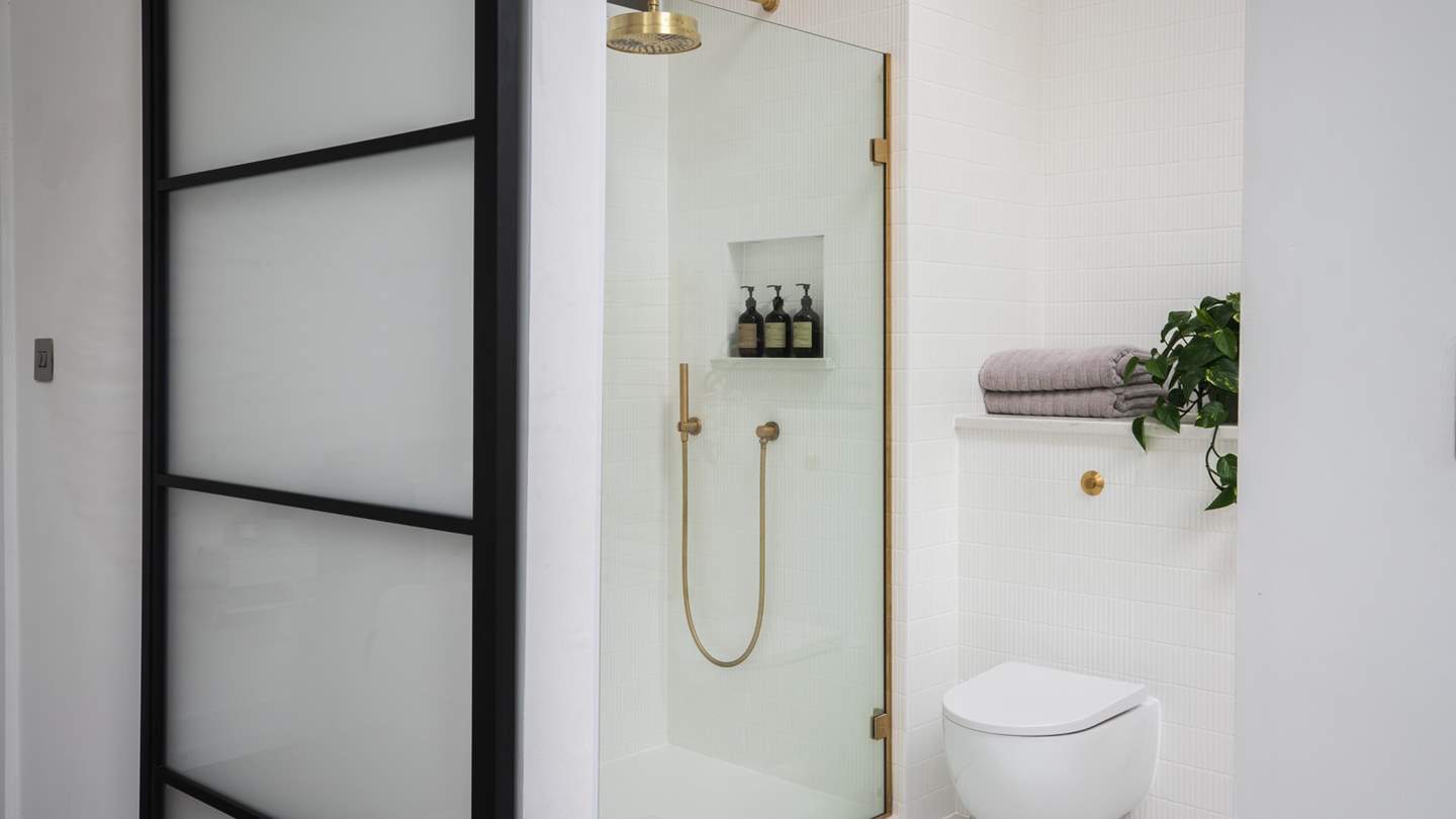 Through the sliding door lies an equally contemporary en suite bathroom