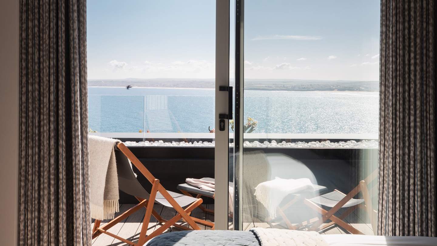 Balmy mornings on the balcony are simply a dream, with two deck chairs and foot stools positioned for you to relish the cerulean vistas
