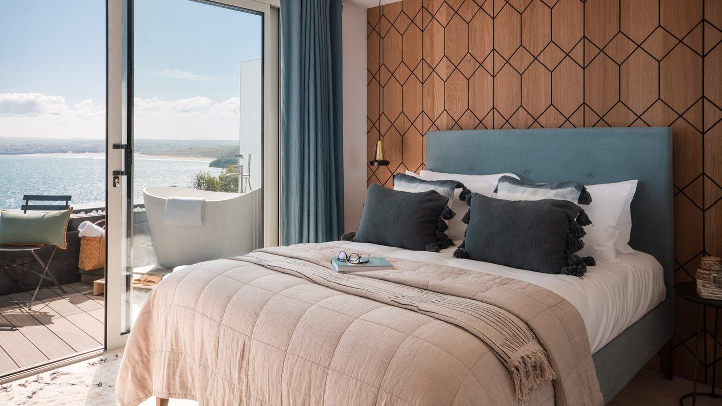 The first bedroom is an oasis of calm, with a heavenly outdoor Victoria and Albert slipper bathtub