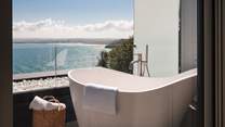 Admire the beautiful seascape from the bubble-topped tub...