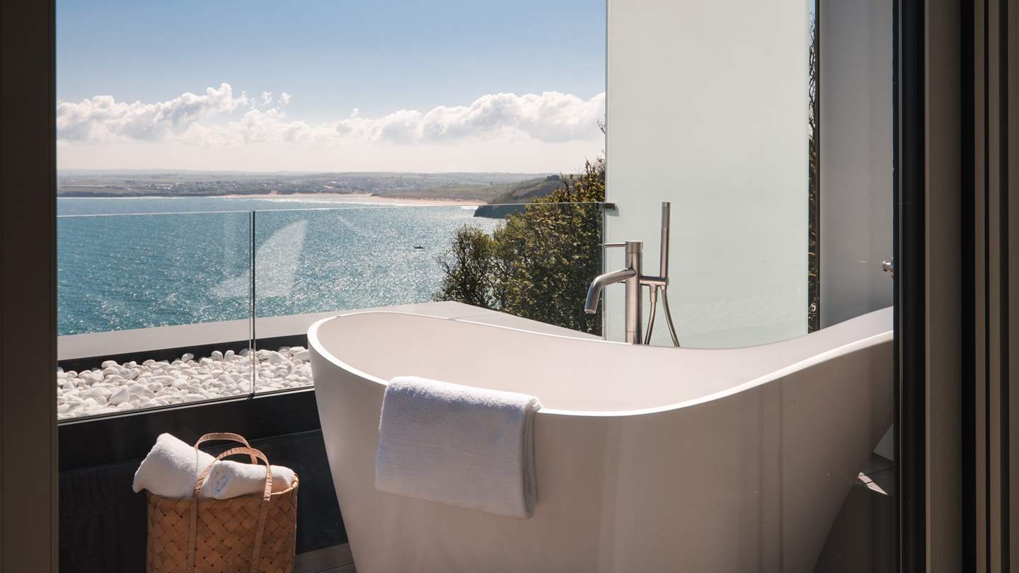 Admire the beautiful seascape from the bubble-topped tub...