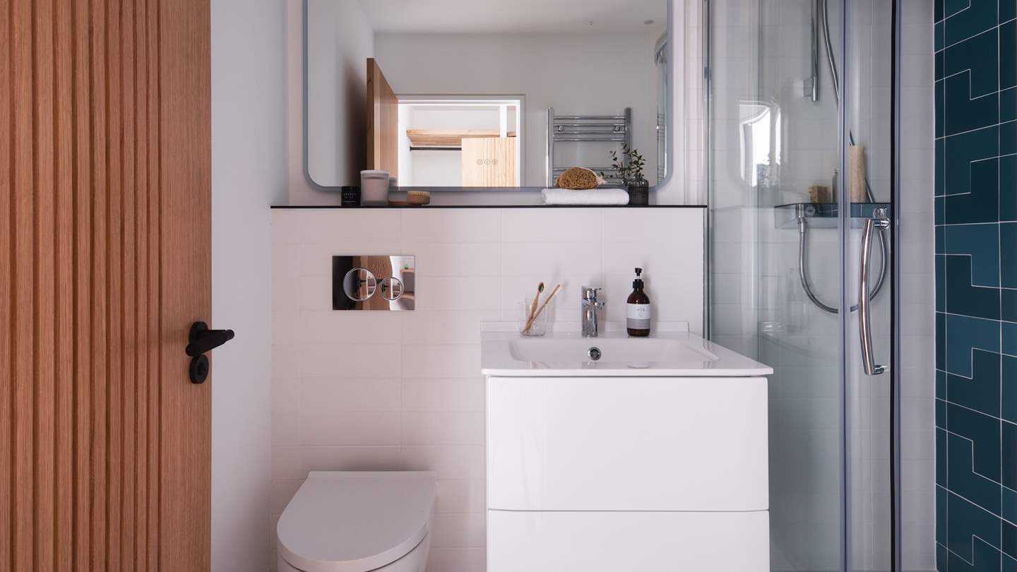 Bedroom five has a sweet ensuite shower room with quirky blue tiles 