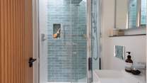 A sleek ensuite shower room provides the perfect setting for refreshing wake-me-up moments, with the addition of a skylight above the shower
