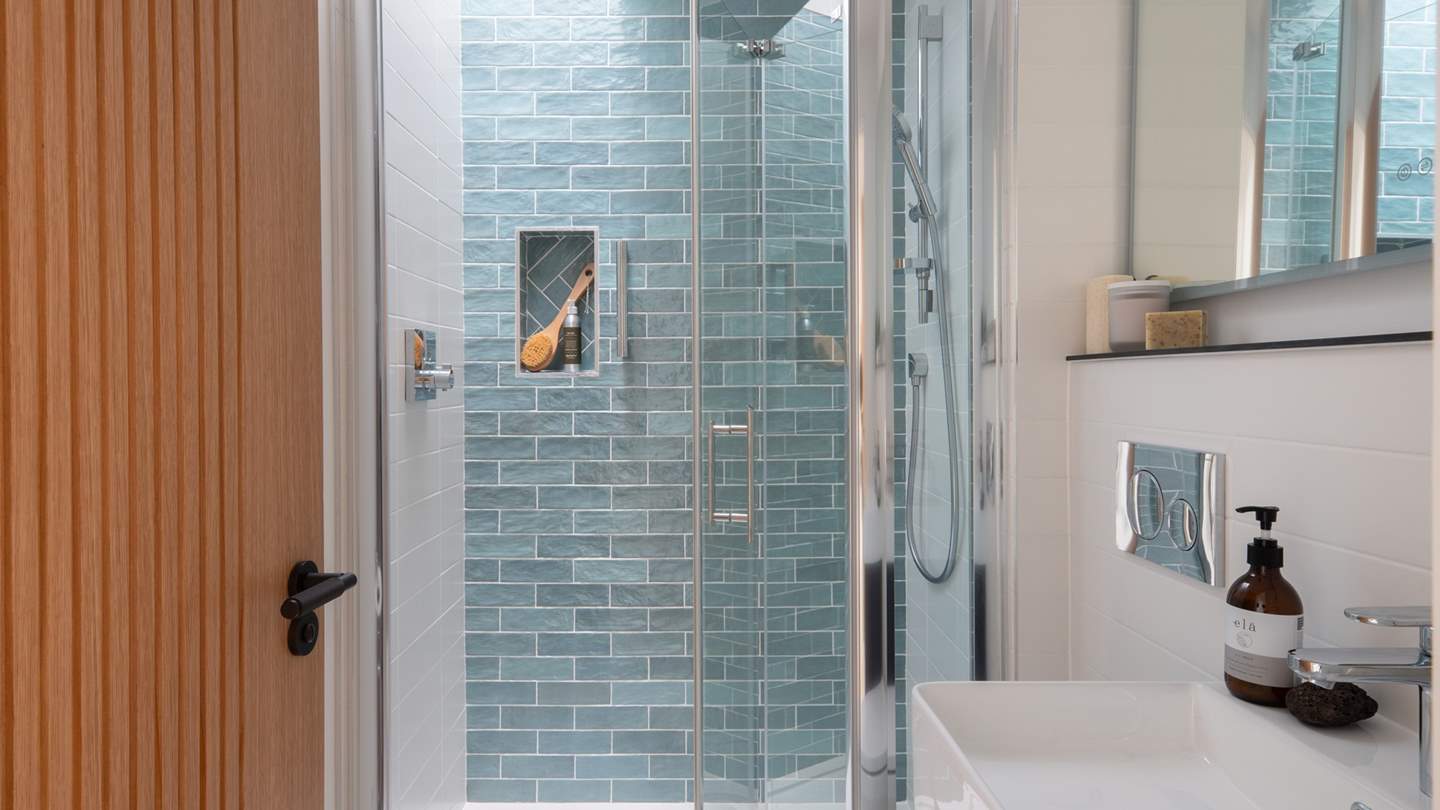 A sleek ensuite shower room provides the perfect setting for refreshing wake-me-up moments, with the addition of a skylight above the shower