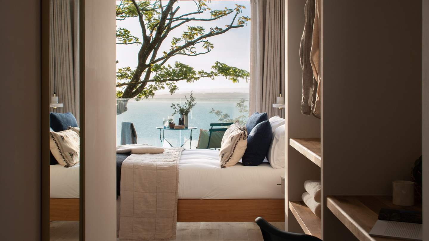 Spiraling down the pearly white staircase, a fourth king size bed can be found