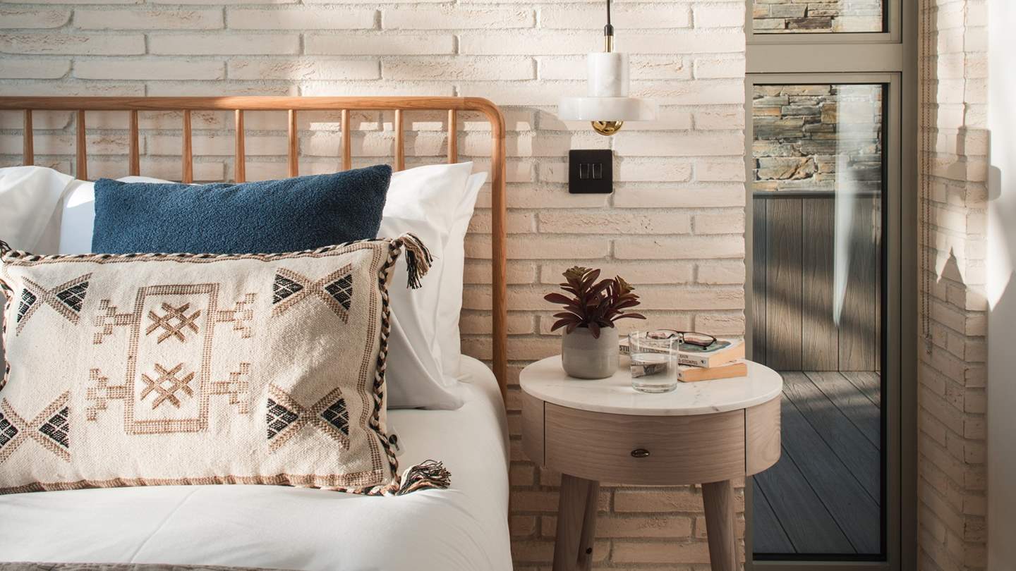 We just love the Scandi oak headboard and sumptuous cushions and throws in shades of cream and blue