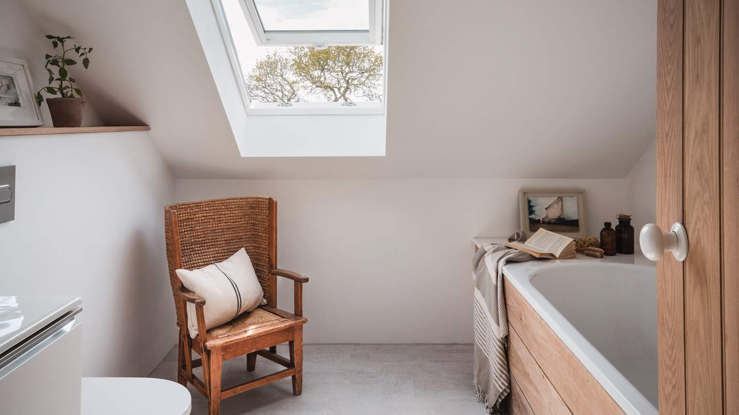 Just next door is the elegant oak-panelled family bathroom