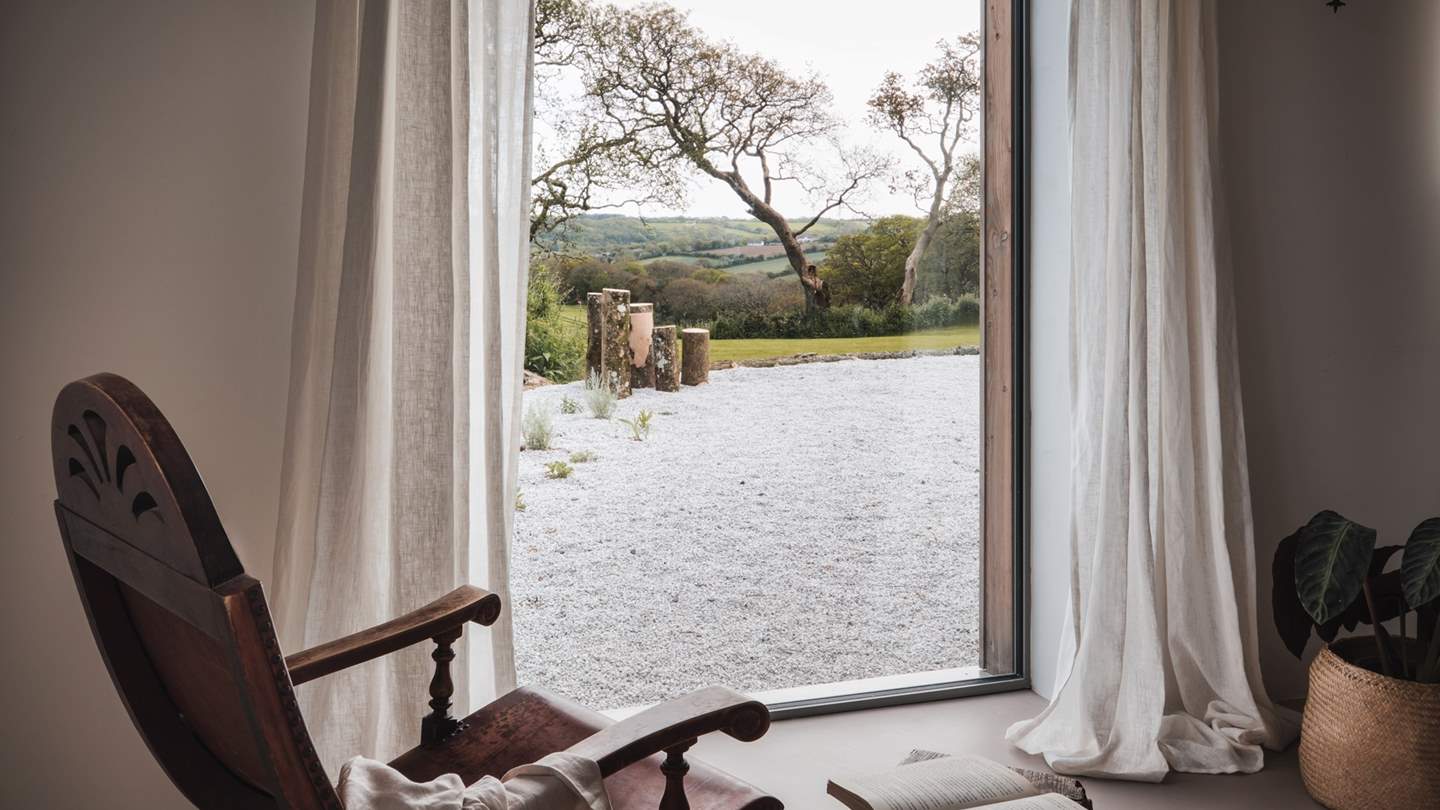 A large window overlooks the garden, where a Beth Chatto inspired garden is a simply otherworldly spot to savour your day-rise blend