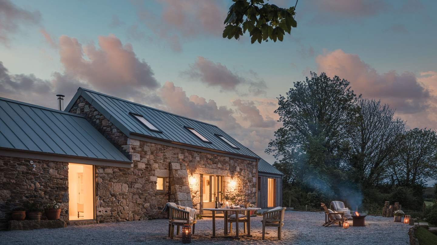 On the front terrace, a round wooden dining table for six promises dreamlike dining beside stunning country scenes... 