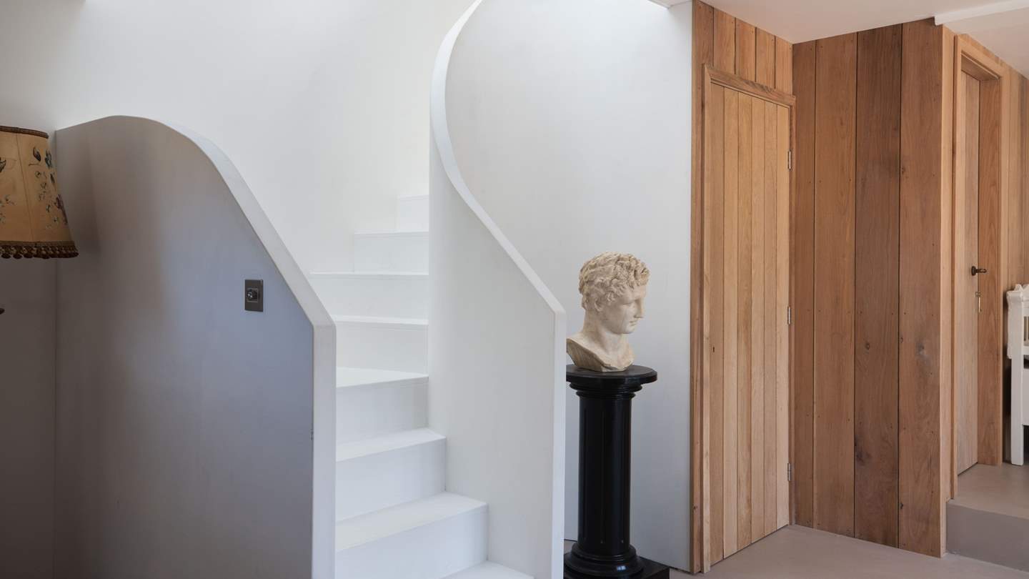 Take the sweeping circular staircase to uncover two more stunning bedrooms... 