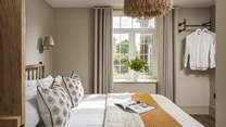 The second bedroom decorated in neutral tones radiates calm