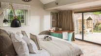The dreamy first bedroom enjoys direct access to the idyllic garden, as well as the stunning Victorian copper bath...