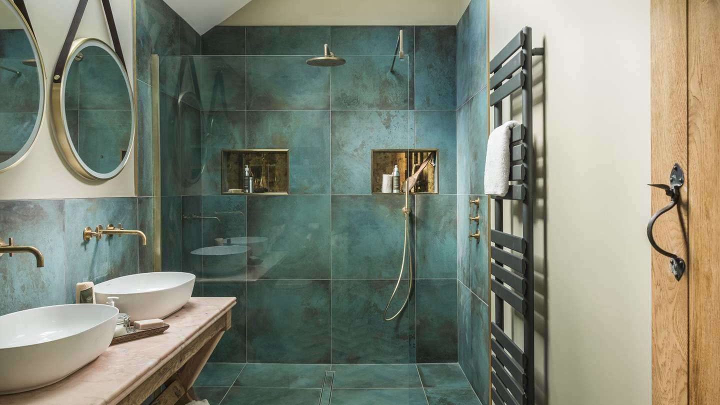 For further comfort, has its own ensuite bathroom with gorgeous turquoise tiling, twin sinks, a heated towel rail and a large, walk-in shower...