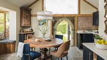 Taking centre stage, a preserved archway is framed by a huge glass pane, presenting an architectural work of art and hinting at the cottage’s historic roots...