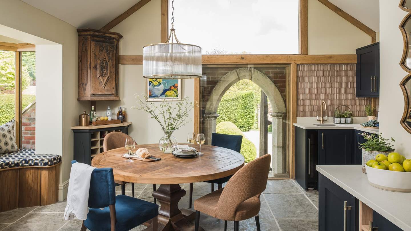 Taking centre stage, a preserved archway is framed by a huge glass pane, presenting an architectural work of art and hinting at the cottage’s historic roots...