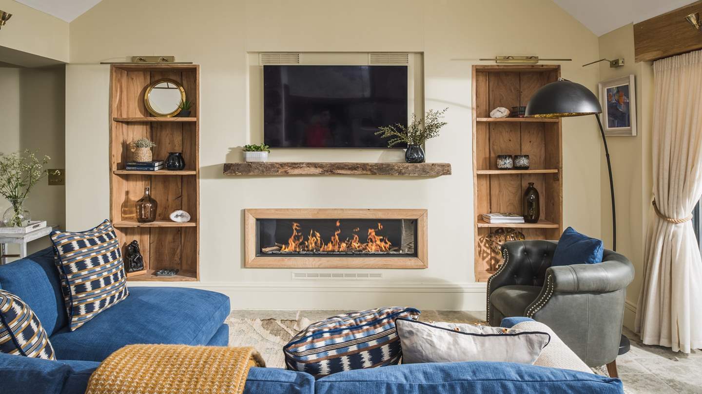 Hugged by inbuilt bookcases is the built in gas wood burning stove, the perfect addition in the winter months