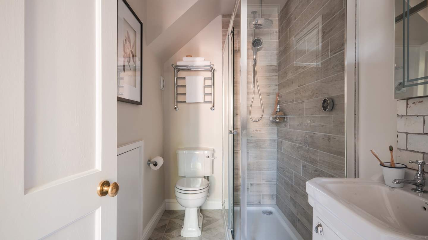 The family bathroom is decorated in a calming palette with natural textures and inflections