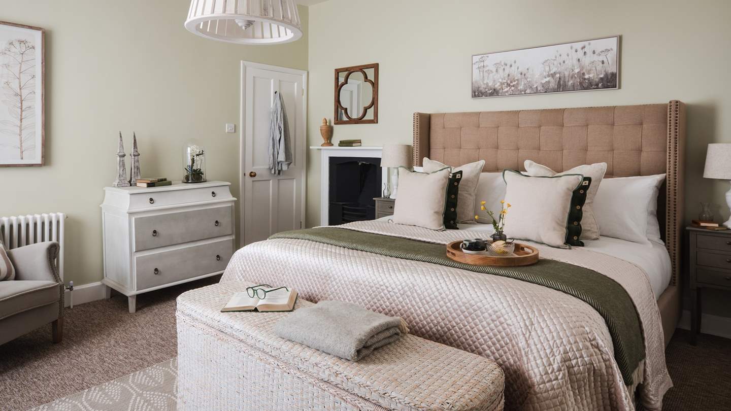 The beautiful master suite features a super king bed dressed in fine linens and married with a whitewashed rattan ottoman bed end...