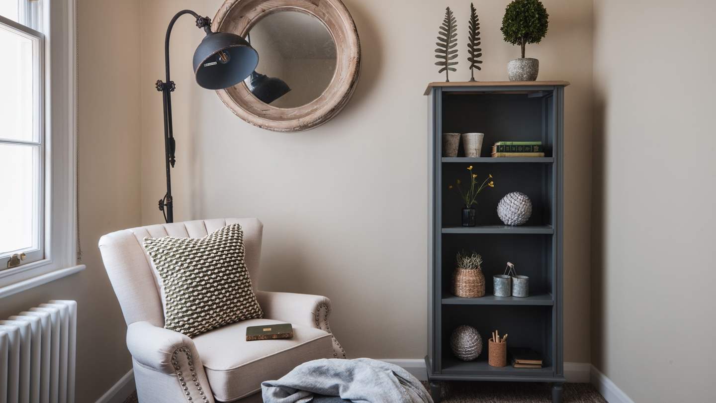 In the corner, a quiet snug resides with an armchair and bookcase, perfect for moments of quietude curled up with a book... 