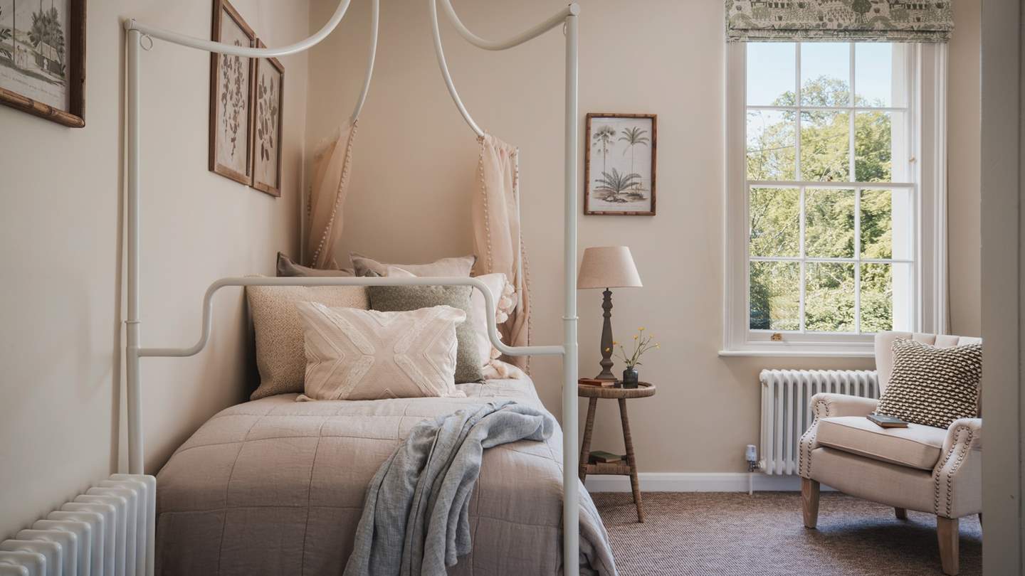 The second bedroom features a lovely garden-view window, cascading natural light across the space